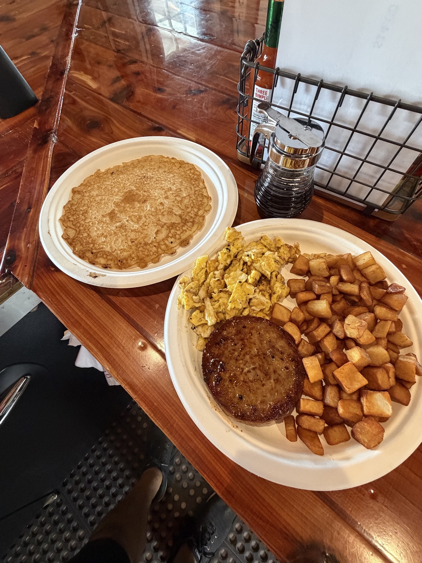 Breakfast plate with pancakes, eggs, sausage, and potatoes at Custer's Last Meal