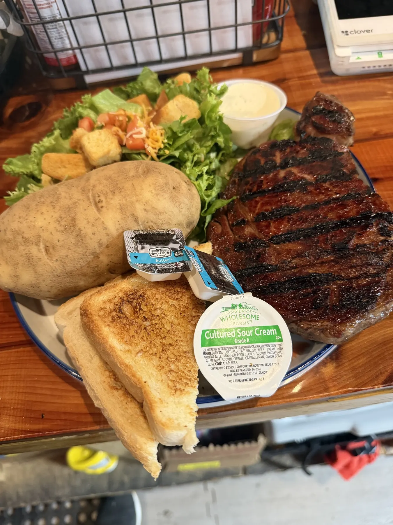 Steak dinner with baked potato, salad, and Texas toast at Custer's Last Meal